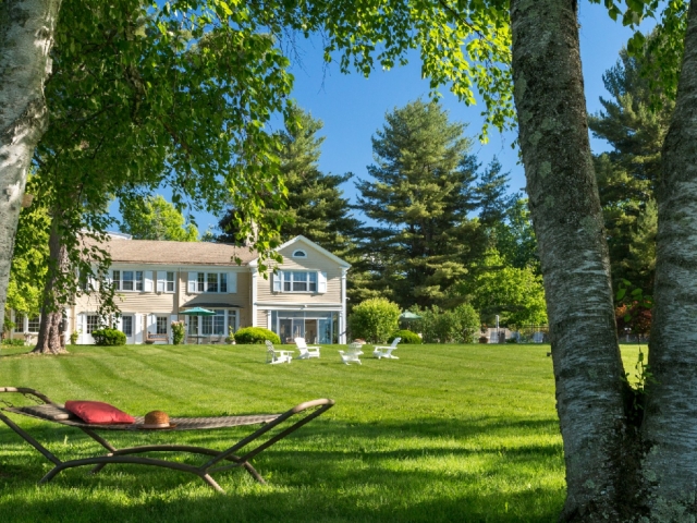 Exterior of Devonfield Inn with large green lawn in front