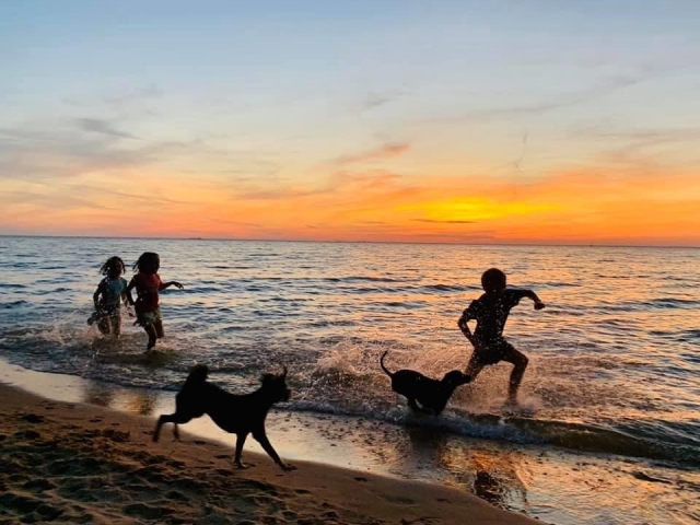 Children running on beach at Jubilee Suites in Fairhope, AL