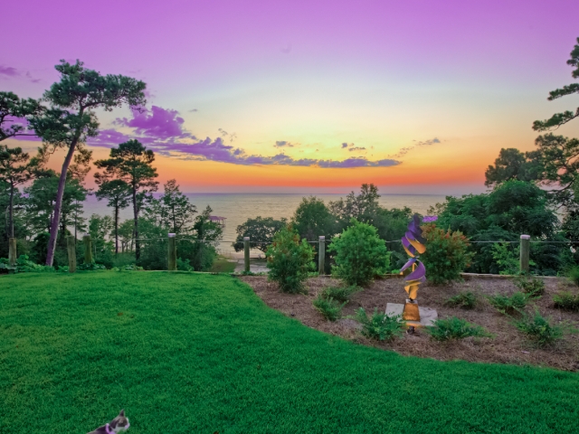 Garden and sunset over Mobile Bay at Jubilee Suites in Fairhope, AL