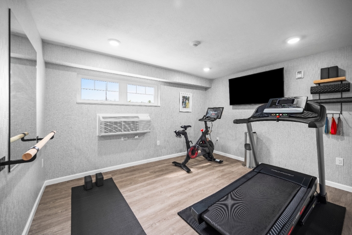 On-site 24/7 fitness room with Peloton bike, treadmill, barre, and yoga mats