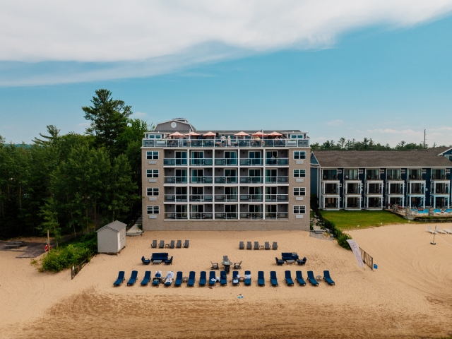 Private beach at Alexandra Inn with complimentary chairs, chaise lounges, fire pit, and towels