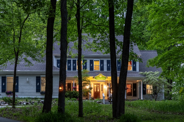 front of property through the trees at dusk