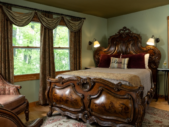guestroom with ornate wood bed