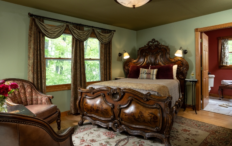 guestroom with ornate wood bed