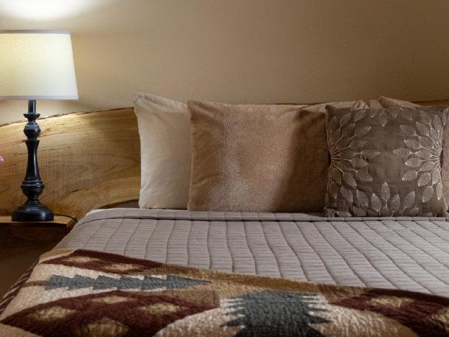 guest room with patterned quilt
