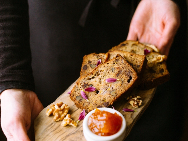 Banana bread on a board with apricot jam