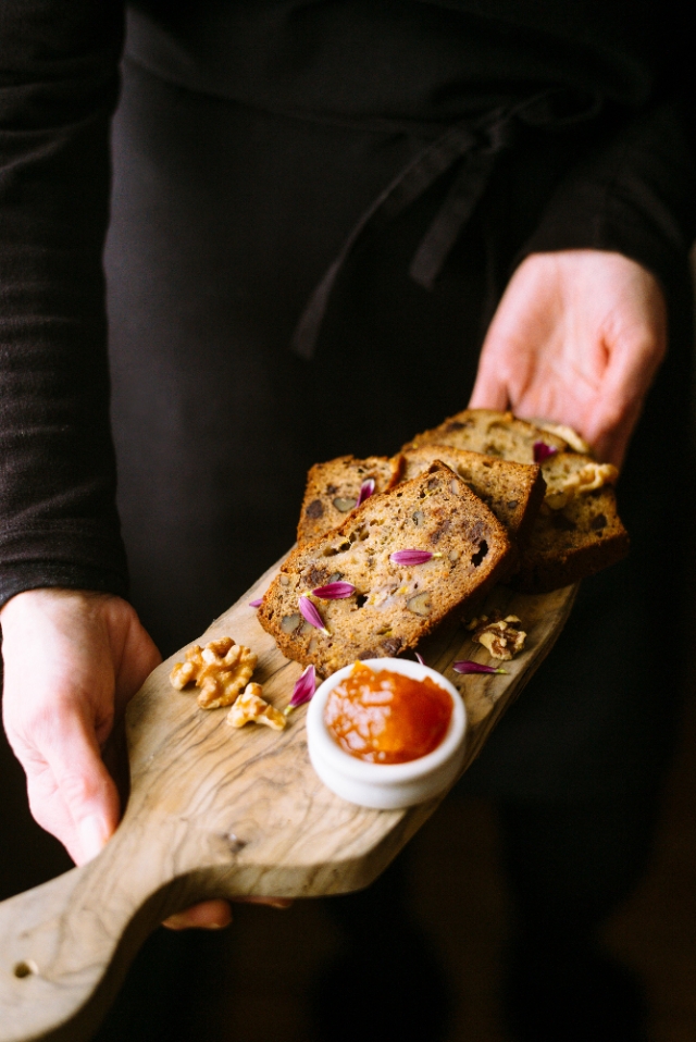 Banana bread on a board with apricot jam
