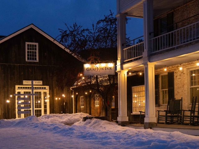 The Grafton Inn at night time in the winter with snow on the ground