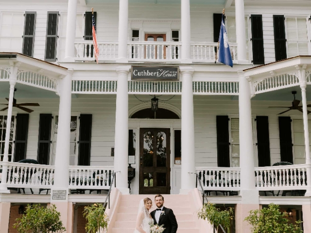 Bride and Groom in front of the Cuthbert House wedding venue.