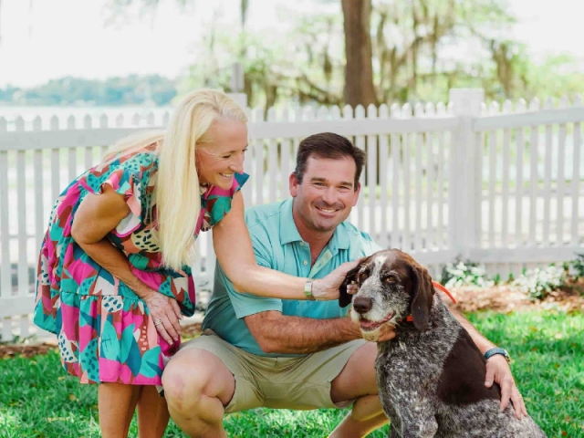Owners Chris & Suzanne Ramm with their dog on the Cuthbert House lawn.