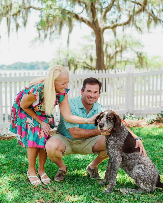 Owners Chris & Suzanne Ramm with their dog on the Cuthbert House lawn.