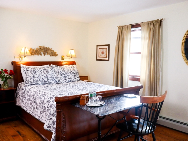 Queen sleigh bed with blue and white paisley comforter, marble desk and chair