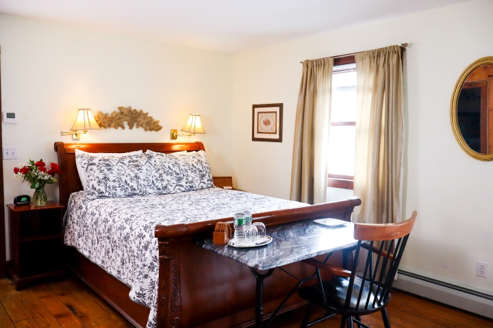 Queen sleigh bed with blue and white paisley comforter, marble desk and chair