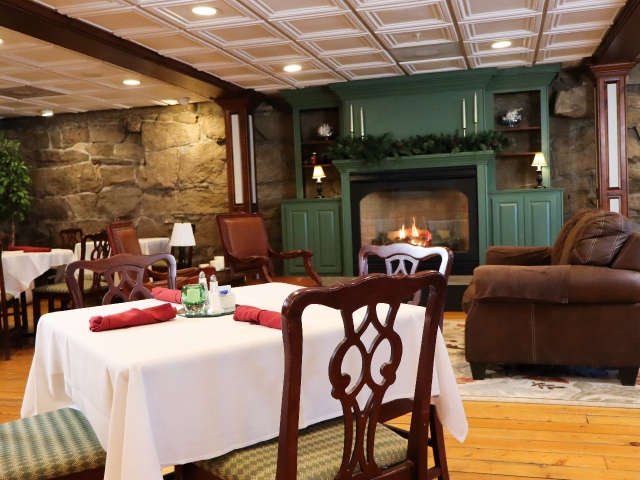 Dining room table with chair, sofa and green fireplace