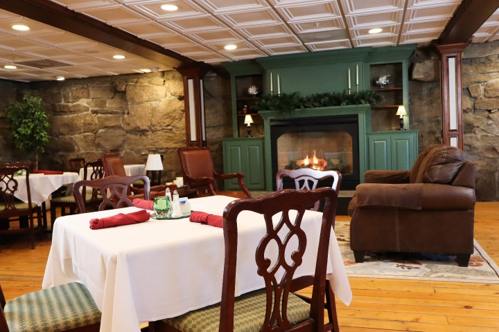 Dining room table with chair, sofa and green fireplace