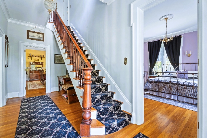 Our main staircase and first‑floor king, where the character of our 1800s home comes into view.