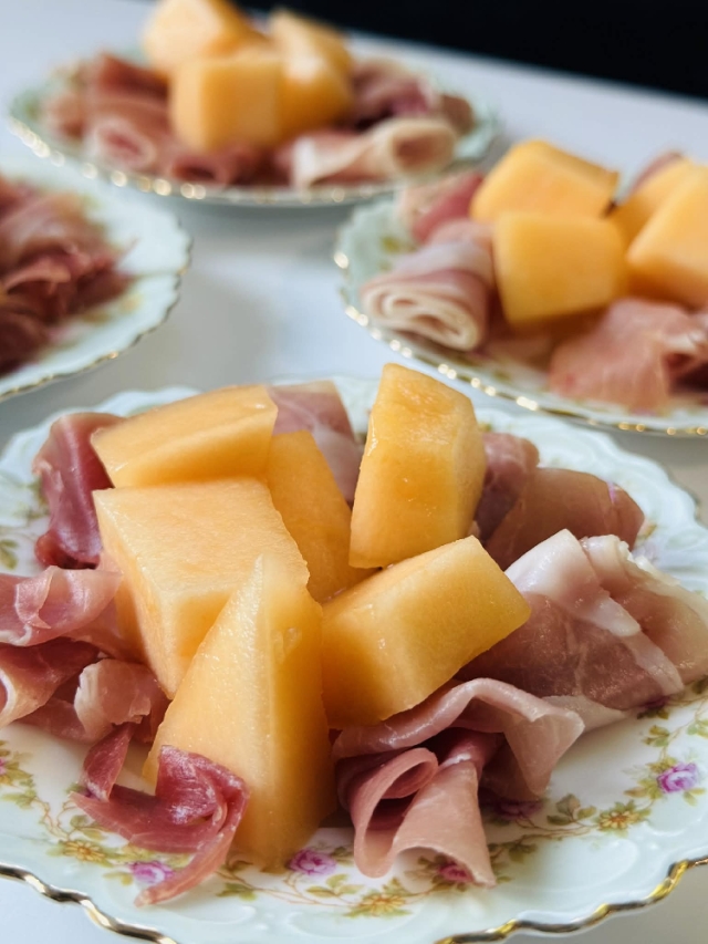 Prosciutto and melon, served on plates old enough to have outlived generations—some from the 1800s—because beauty tastes different when it’s carried on history.