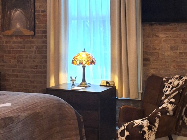 Guest room with brick wall