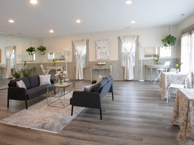 Newly remodeled studio with two comfortable loveseats and plenty of room to gather, creating a bright, welcoming space for bridal parties, retreats, and celebrations.
