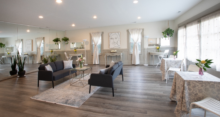 Newly remodeled studio with two comfortable loveseats and plenty of room to gather, creating a bright, welcoming space for bridal parties, retreats, and celebrations.