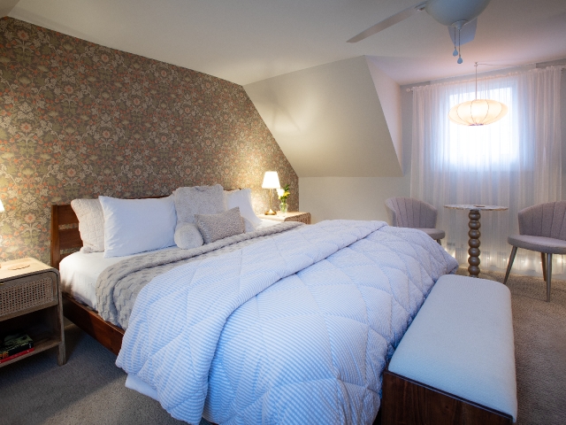 A plush king-size bed invites guests to settle in and relax in the spacious Honeymoon Suite at Prairie Guest House.
