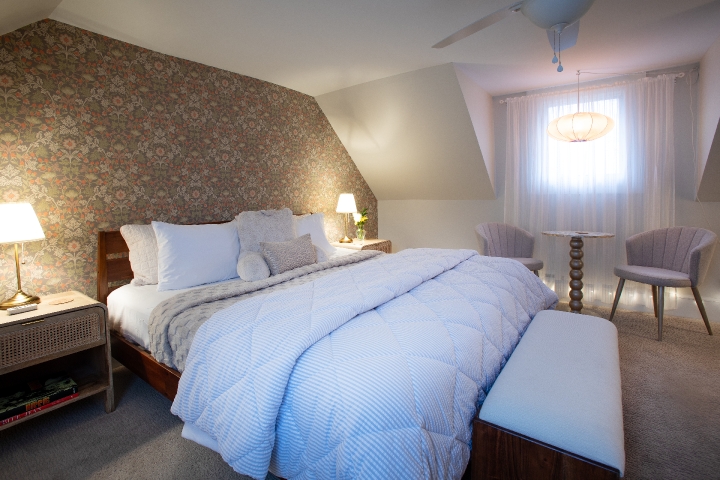 A plush king-size bed invites guests to settle in and relax in the spacious Honeymoon Suite at Prairie Guest House.