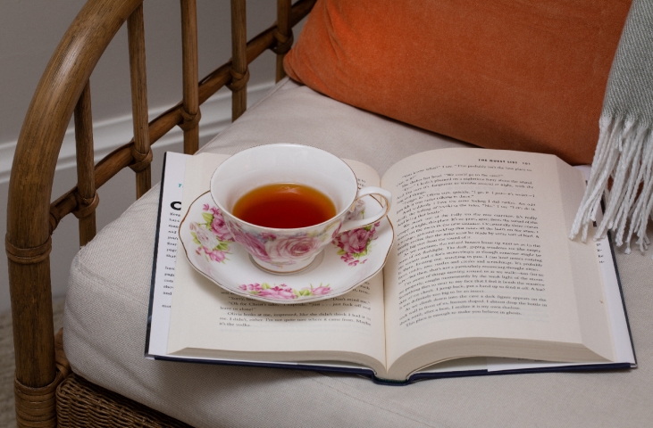 A cozy chair awaits at Prairie Guest House, inviting guests to relax with a steaming cup of tea and an open book.