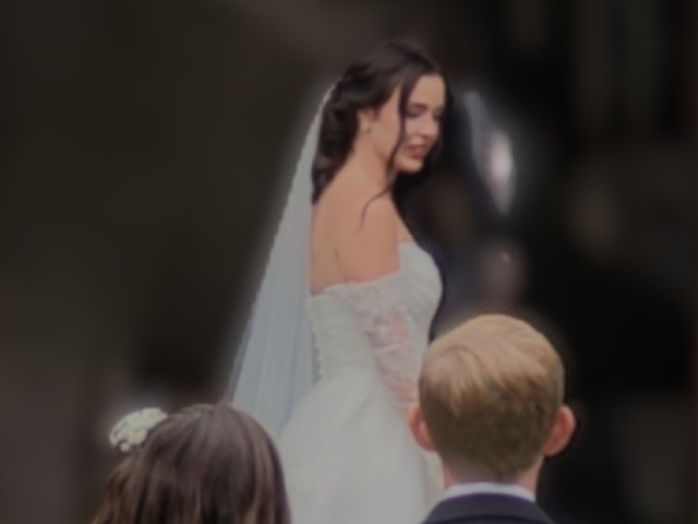 Bride in a beautiful white wedding dress and veil steps out of Prairie Guest House for a special first look.