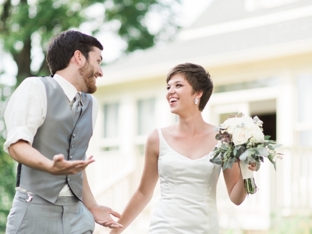Newlyweds stroll through the courtyard after their ceremony, smiling at one another in the first joyful moments of married life.